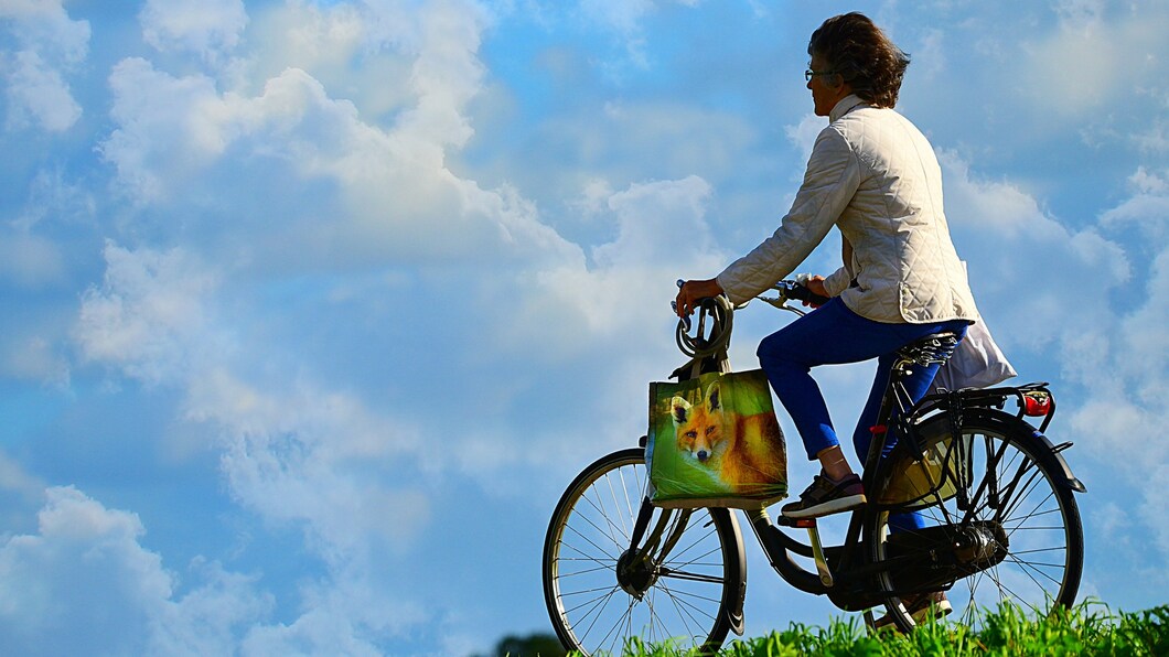 man fietst op dijk bij mooi weer